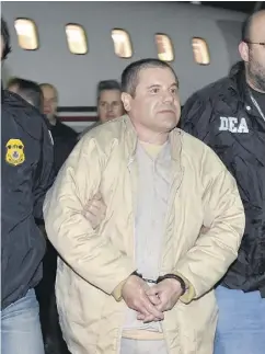  ?? U. S. LAW ENFORCEMEN­T VIA THE ASSOCIATED PRESS ?? Joaquin “El Chapo” Guzman is escorted from a plane in New York on Thursday night. The infamous drug kingpin was extradited from Mexico at the request of the U. S.