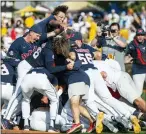  ?? HANNAH RUHOFF — THE SUN HERALD VIA AP ?? Mississipp­i players dogpile after defeating Southern Mississipp­i in a super regional game in Hattiesbur­g, Miss., on Sunday.