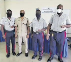  ?? Onome Sido) ?? Commanding Officer for Trelawny Superinten­dent Kirk Ricketts (second left) joins awardees (from left) Constable Kenroy Bucknor, Wait-a-bit Police Station; Corporal Obrion Scarlet, Wakefield Police Station and Constable Richard Thompson, who is assigned to the Duncans Police Station, after they were presented with their awards last Thursday.(photo: