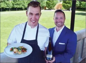  ?? STEVE MacNAULL/The Okanagan Weekend ?? Patrick Gayler, left, chef at The Terrace Restaurant at West Kelowna’s Mission Hill Winery, shows off the catch-of-the day pan-seared scallops, while director of wine experience Graham Nordin holds the wine that perfectly pairs with it, 2015 Perpetua...