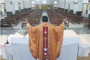  ??  ?? Roman Catholic Priest Father P.Gnana Reddy celebrates a private Mass on a Palm Sunday event during a 21-day government-imposed nationwide lockdown at the Saint Joseph’s Church in Secunderab­ad, the twin city of Hyderabad, on Sunday in India.