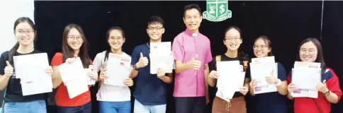  ??  ?? Fr Francis Lim with straight As achievers (from left) Erica Tiong Syn Hui, Er Sing Tong, Ruby Ho Xin Tung, Sie Duong Xing, Nydra Lynn Yong, Cherie Choo Jia Yii and Cristabel Chua Jia Sin.