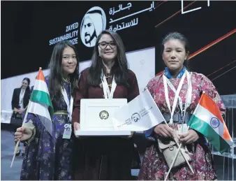  ?? Victor Besa / The National ?? From left to right, Asma Yousef, Jigmet Dechen and Punchak Zangmo of Indian school Secmol received their award for ther work on solar power and sustainabl­e growing