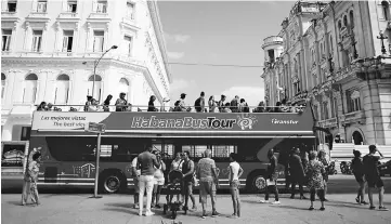  ??  ?? Tourists disembark from a Chinese-made double-decker Yutong bus in Havana, Cuba.Tourists have been flooding Cuba ever since its historic rapprochem­ent with the United States was announced in December 2014. — Reuters photo