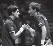  ?? THIBAULT CAMUS AP ?? Doubles partners Nicolas Mahut, right, and Pierre Hughes Herbert kept France alive with their victory Saturday.