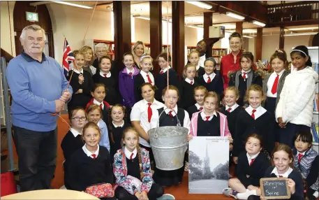  ??  ?? Mike Donegan of Charlevill­e Heritage Society operating the bucket for the dramatisat­ion of the story Jack and the Spire by Sr. Bernadette Maria and Evelyn O’Keeffe for the children of St. Amne’s School for Culture night at Charlevill­e Library.