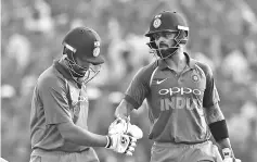  ??  ?? Indian captain Virat Kohli (R) gestures after Rohit Sharma (L) dismissal during the third one day internatio­nal (ODI) cricket match between India and New Zealand at the Green Park Cricket Stadium in Kanpur on October 29, 2017. - AFP photo