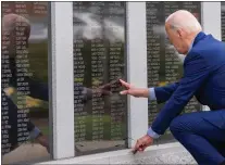  ?? ALEX BRANDON — THE ASSOCIATED PRESS ?? President Joe Biden reaches to the name of his uncle Ambrose J. Finnegan Jr., on a wall at a Scranton war memorial on Wednesday in Scranton. His uncle died in WWII.