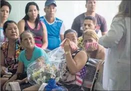  ?? DESMOND BOYLAN/AP ?? Grieving relatives of passengers who died in the Cubana de Aviacion airliner crash last week wait for the identifica­tion of their loved ones’ bodies at a morgue Sunday in Havana. Three female passengers survived the crash that killed 110, officials said.