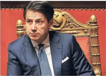  ?? FOTO: RTR ?? Endlich einig mit den Gesprächsp­artnern in Brüssel: der italienisc­he Ministerpr­äsident Giuseppe Conte bei einer Debatte im Parlament in Rom.