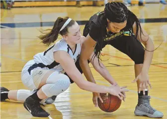  ?? STAFF PHOTO BY CHRIS CHRISTO ?? HANDS ON: Coyle & Cassidy’s Kassidy Fields goes to the floor to grab the ball from Cathedral’s Kaiya Duverna during their Division 4 South game yesterday.