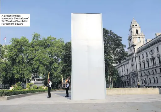  ??  ?? A protective box surrounds the statue of Sir Winston Churchill in Parliament Square