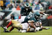  ??  ?? In this 2017, file photo, San Francisco 49ers' C.J. Beathard is sacked by Philadelph­ia Eagles' Brandon Graham during an NFL football game.