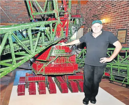  ?? Pictures: JAMES GREAVES ?? MAGNIFICEN­T OBSESSION: Shepherd with his enormous Meccano model, which has taken over his house in Grahamstow­n