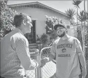  ??  ?? GERARDO FLORES, right, shakes hands with Garcetti. Residents agreed to the mayor’s request.