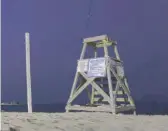  ?? ANTHONY VAZQUEZ/SUN-TIMES FILE ?? A lifeguard tower at Oak Street Beach sits empty last summer.