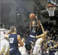  ?? SUBMITTED PHOTO BY STEVE MUSCO ?? Yale’s Trey Phills goes up for a shot during Saturday’s Ivy League semifinal in Philadelph­ia.