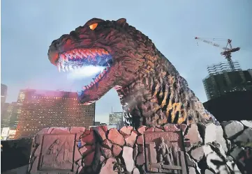  ?? — AFP photo ?? File photo shows a real-scale head of Godzilla displayed on the balcony of a newly-built commercial complex as a new Tokyo landmark during its unveiling at Kabukicho shopping and amusement district in Tokyo on April 9, 2015.