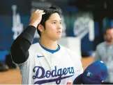  ?? LEE JIN-MAN/AP ?? Dodgers manager Dave Roberts said two-way star Shohei Ohtani, above, will start a throwing program soon and might play in the field this season in addition to his regular DH duties. Ohtani is returning from Tommy John surgery and will not pitch until 2025.