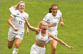  ?? Rui Vieira Associated Press ?? CHLOE KELLY celebrates in a style reminiscen­t of Brandi Chastain after her goal in extra time defeated Germany 2-1 to win the European Championsh­ip.