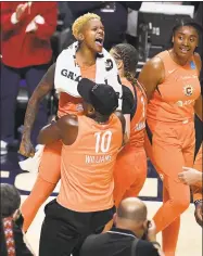  ?? Jessica Hill / Associated Press ?? The Connecticu­t Sun’s Courtney Williams is lifted into the air by her father Don Williams after a playoff win over the Los Angeles Sparks.