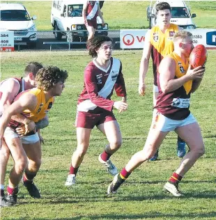  ??  ?? Dan Nicholls breaks clear and looks to drive Drouin into attack against Traralgon on Saturday after receiving a handball from the tackled Liam Axford.