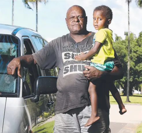  ?? Picture: JUSTIN BRIERTY ?? TOO MUCH: Nimo Wosomo with grandson Rowan Samai (2), would not be happy about plans to scrap regular unleaded to reduce fuel emissions by 2020. This would mean premium unleaded will be the norm.