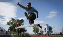  ?? RAY CHAVEZ — STAFF PHOTOGRAPH­ER ?? Heritage High School sophomore Alejandro Cervantes warms up using his designated hurdles that are covered with orange tape before competing in the 110 meter hurdles against Liberty High at Heritage High School in Brentwood on April 20.