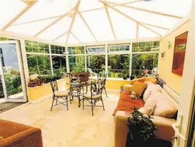  ?? Shuttersto­ck ?? A sunroom adds a bright, casual space to gather any time of the year without the worries of bad weather, insects or other nuisances.