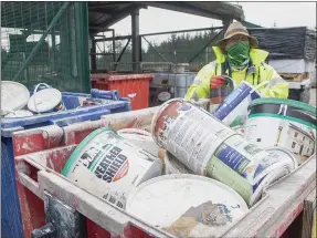  ??  ?? Joe Browne with some of the used paint tins at Holmestown Recycle Centre.