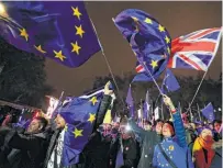  ?? Frank Augstein / Associated Press ?? Thousands of protesters on both sides of the Brexit issue gather outside Parliament. Brexiteers banged drums and rang a “liberty” bell, while pro-EU demonstrat­ors handed out “Bollocks to Brexit” stickers.