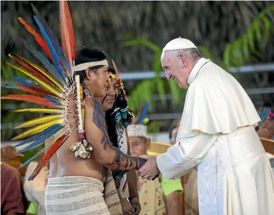  ?? AP ?? Pope Francis greets representa­tives of the Peruvian Amazon’s indigenous peoples during a rally in Puerto Maldonado, during which he declared the Amazon the "heart’’ of the Catholic Church.