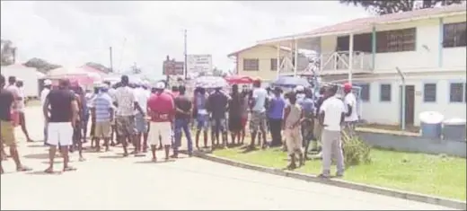  ??  ?? Some of the protesters on Tuesday in front of the Guyana Geology and Mines Commission’s Mahdia office.