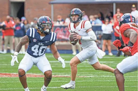  ?? BRUCE NEWMAN/SPECIAL TO THE CLARION LEDGER ?? Navy team quarterbac­k Walker Howard (7) rolls out during last year’s Grove Bowl at Vaught-hemingway Stadium in Oxford, Miss.