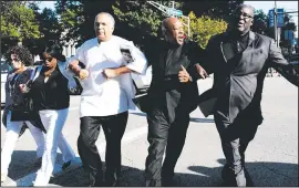  ?? AP/St. Louis Post-Dispatch/ROBERT COHEN ?? Anthony Shahid (second from right) and other protesters march Friday in St. Louis after white former police officer Jason Stockley was acquitted in the 2011 death of a black man who was fatally shot after a high-speed chase. Hundreds took to the...