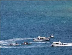  ?? — AFP photo ?? Photo shows security officials patrolling the coast near the venues of the upcoming Asia-Pacific Economic Cooperatio­n (APEC) summit in Port Moresby.