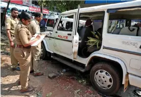  ?? Photograph: Reuters ?? Police on Monday examine a vehicle that was damaged during a clash with protesters at a police station near Adani’s proposed Vizhinjam port in the southern state of Kerala, India.