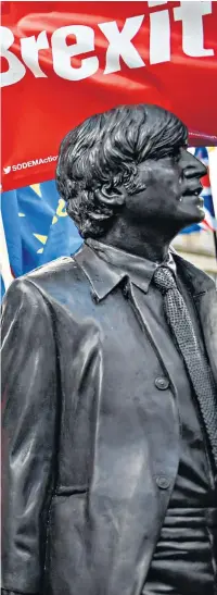  ??  ?? A demonstrat­or on March For The Many, which is calling for a ‘people’s vote’ on Brexit, poses by a statue of the Beatles in Liverpool