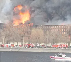  ?? OLGA MALTSEVA/AGENCE FRANCE-PRESSE ?? SMOKE and flames rise from a burning historic factory in Saint Petersburg.