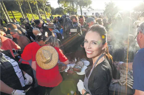  ??  ?? Jacinda Ardern’s breakfast barbecue skills went down well during Waitangi Day celebratio­ns.