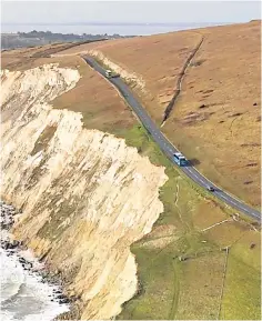  ?? ?? A coach passes close to the eroded cliff edge on the Isle of Wight’s Military Road