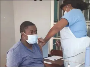  ??  ?? Zimbabwe Associatio­n of Doctors for Human Rights executive director Calvin Fambirai receiving his first dose of the Sinovac Chinese-made vaccine at Belvedere Satellite Clinic in Harare on Friday