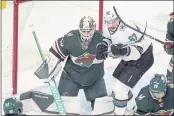  ?? JIM MONE — THE ASSOCIATED PRESS ?? The Sharks’ Matt Nieto (83) is surrounded by green jerseys as he positions himself by Minnesota Wild goalie Cam Talbot during the first period on Tuesday in St. Paul, Minn.