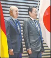  ?? David Mareuil The Associated Press ?? Germany’s Chancellor Olaf Scholz and Japan’s Prime Minister Fumio Kishida attend a ceremony Saturday in Tokyo.