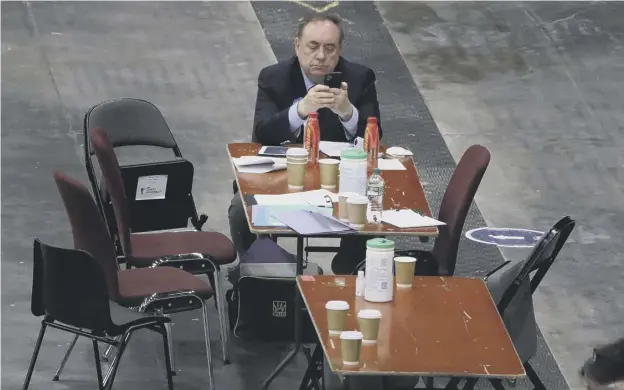  ??  ?? 0 ALBA party leader Alex Salmond looks at his phone as votes are counted for the Scottish Parliament­ary Elections at the P&J LIVE/TECA, Aberdeen