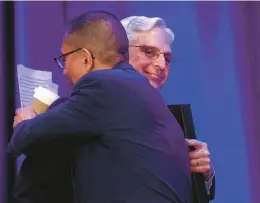  ?? ANTONIO PEREZ/CHICAGO TRIBUNE ?? U.S. Attorney General Merrick Garland, right, greets Eddie Bocanegra, senior director for Heartland Alliance READI Chicago, at the Community Based Violence Interventi­on and Prevention Initiative Conference in Chicago on Wednesday.