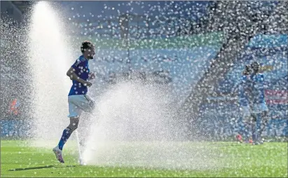  ??  ?? Jamie Vardy of Leicester City jogs past pitch sprinklers before home game against Brighton in June