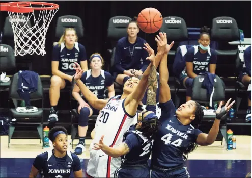  ?? David Butler II / Pool photo via Associated Press ?? UConn’s Olivia Nelson-Ododa (20) and Xavier forward Ayanna Townsend battle for a rebound during Saturday’s game in Storrs.