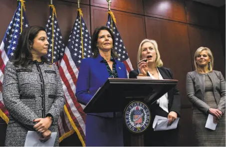  ?? Zach Gibson / Bloomberg ?? Rep. Cheri Bustos, D-Ill., stands at the lectern on Capitol Hill while Sen. Kirsten Gillibrand, D-N.Y. (second from right), responds to questions about sexual harassment legislatio­n. Many high-profile figures have had to answer for their alleged abuse.