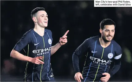  ??  ?? Man City’s two-goal Phil Foden, left, celebrates with David Silva